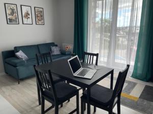 a living room with a table with a laptop on it at Kazimierza Wielkiego 32 in Gdańsk