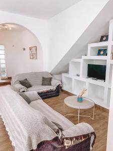 a living room with a couch and a tv at GreenTree House in Corralejo