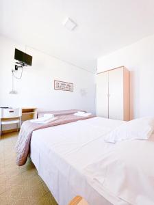 Postel nebo postele na pokoji v ubytování Hotel Ambassador
