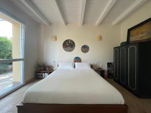 a bedroom with a large bed and a large window at Pioppi Neri R&B in Felino