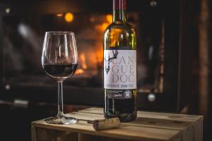 a bottle of wine and a glass on a table at Chalet F'Net in Saint-Gervais-les-Bains