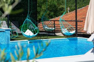 Twee hangmatten hangen boven een zwembad bij Apartments Golden View in Kotor