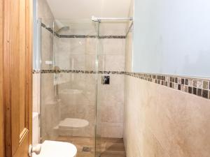 a bathroom with a glass shower with a toilet at 1 Lake View in Coniston +15 photos