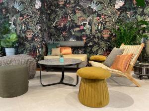 a room with chairs and a table and a wall with plants at Cocoon Salzburg Hauptbahnhof in Salzburg +51 photos