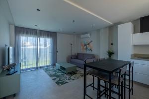 a living room with a table and a couch at ON City Apartments in Matalascañas