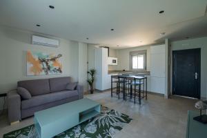 a living room with a couch and a table at ON City Apartments in Matalascañas