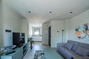 a living room with a couch and a tv at ON City Apartments in Matalascañas