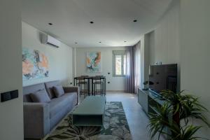 a living room with a couch and a table at ON City Apartments in Matalascañas
