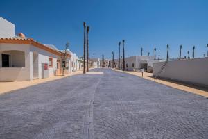 a cobblestone street in the middle of a town at ON City Apartments in Matalascañas
