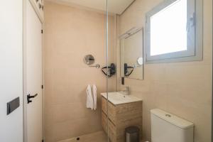 a bathroom with a toilet and a sink and a shower at ON City Apartments in Matalascañas