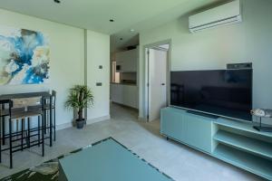 a living room with a large flat screen tv at ON City Apartments in Matalascañas