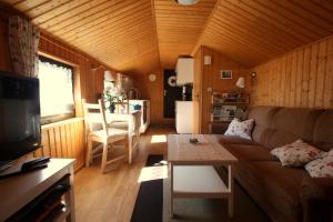 a living room with a couch and a table at Ferienhaus beim Imker in Marienberg