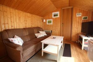 a living room with a couch and a table at Ferienhaus beim Imker in Marienberg +14 photos