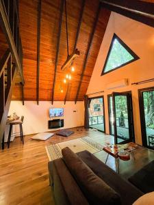 a living room with a couch and a large window at Meselik Park Bungalov in Sapanca