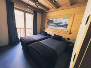 Posteľ alebo postele v izbe v ubytovaní Carosello Lodge Livigno