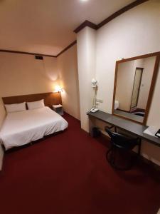 Postel nebo postele na pokoji v ubytování Long Cherng Hotel