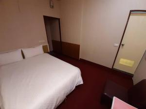Postel nebo postele na pokoji v ubytování Long Cherng Hotel