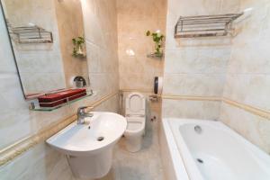 een badkamer met een wastafel, een toilet en een bad bij Ly Ly Hotel in Ho Chi Minh-stad