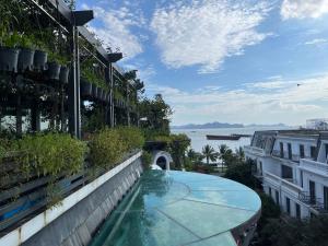 a swimming pool on the side of a building at Paris Of Dragon Bay in Ha Long