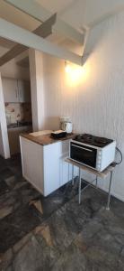 a small kitchen with a microwave on a table at Nora Norita in Batsi +74 photos