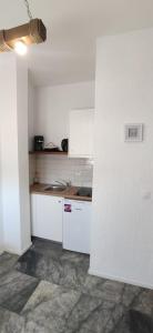 a kitchen with white cabinets and a counter top at Nora Norita in Batsi +73 photos