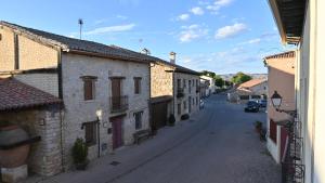 an empty street in a town with buildings at Casa Rural Antigua Botica in Torremocha de Jarama