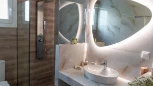 a bathroom with a sink and a mirror at Averto House Lefkada in Lefkada