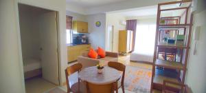 a living room with a small table and a kitchen at Studio with Privacy Balcony and NETFLIX at TimurBay Sea Front Residence in Kuantan
