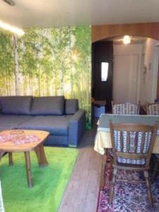 a living room with a blue couch and a table at Haus-Sonnenbichl-Wohnung-102 in Oberstdorf