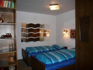 a bedroom with a bed with blue pillows on it at Haus-Sonnenbichl-Wohnung-102 in Oberstdorf