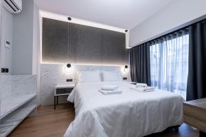 Ein Bett oder Betten in einem Zimmer der Unterkunft Ethereal Athεns