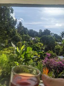 a glass of wine with a view of a garden at Tiu Kelep Homestay in Senaru