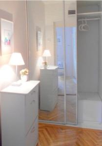 a bathroom with a shower and a desk with a lamp at Apartment Bella Vista in Belgrade +7 photos