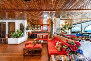 a living room with red couches and a table at Hotel Tsagarakis Beach in Amoudara Herakliou
