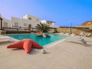 a swimming pool with two stuffed animals in the water at Secret Island in Tourlos