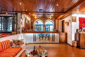 a living room with a couch and a table at Hotel Tsagarakis Beach in Amoudara Herakliou