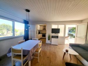 a kitchen and dining room with a table and a couch at Apartments Buktenica in Bol +18 photos