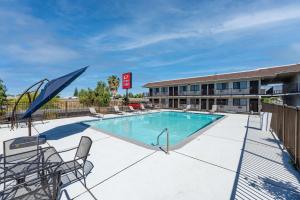 una piscina con sillas y un hotel en Econo Lodge Stockton near I-5 Fairgrounds, en Stockton