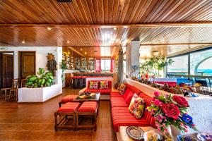 a living room with red couches and a table at Hotel Tsagarakis Beach in Amoudara Herakliou