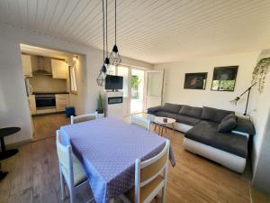 a living room with a table and a couch at Apartments Buktenica in Bol