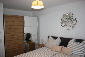 a bedroom with a bed and a large mirror at Traumwohnung Füssen 14 in Füssen