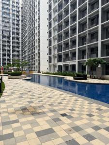 a pool in the middle of a building with tall buildings at S Shore in Manila
