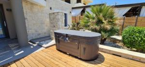 a trash can sitting on a wooden deck at Villy Luxury Home 2 in Ayiá