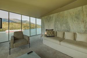 a living room with a couch and a chair at Octant Douro in Castelo de Paiva