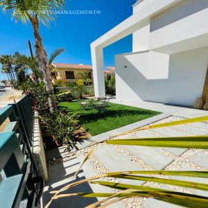 a view of the backyard of a house at By the Beach Villa 7 in Protaras +40 photos