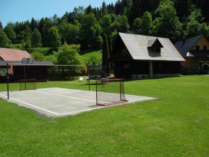 a tennis court in front of a house at Chata Sipkova I in Terchová