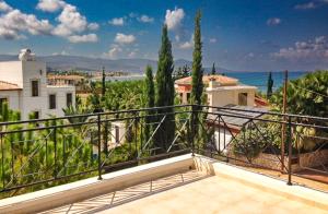 a balcony of a house with a view of the ocean at Theos Club Villas in Polis Chrysochous