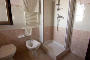 a bathroom with a shower and a toilet and a sink at Villa Jolanda & Carmelo in Villaggio Mosè +147 photos
