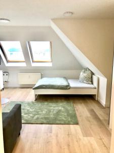 a living room with a bench under the stairs at Helles und ruhiges Apartment direkt am Flughafen Leipzig Halle in Schkeuditz