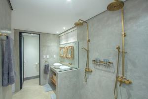 a bathroom with a shower and two sinks in it at Kruger's Keep - Luxury Couples Haven in Marloth Park +31 photos